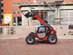 Telehandler with boom raised on a construction site